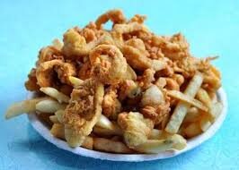 images Clam strip dinner plate with french fries served on a white plate. Blue background