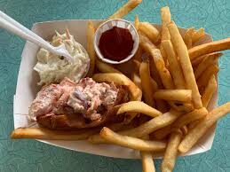 images (8) Lobster roll with french fries, coleslaw, and ketchup. Menu item. Blue background