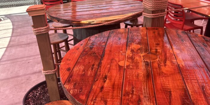 Outside patio Wooden outdoor tables on top of kegs with wooden bar stools on Kool Kone's outdoor patio